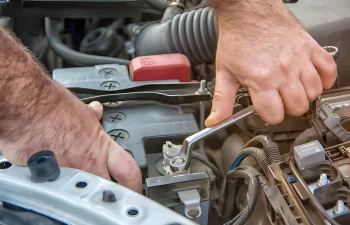 What are the safety precautions when changing a car battery?